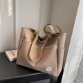 Minimalist beige canvas tote bag with front pockets and 'good luck' patch detail - Khaki