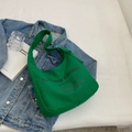 Vibrant green canvas hobo tote bag with black slogan text on denim jacket - Green
