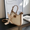 Cream vintage-style faux leather underarm bag with a brown strap and knitted rabbit charm - With Pendant / Off-white