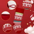 Detail showing red knitted Christmas stocking with white snowflake patterns and hanging loop - Snowflake Style