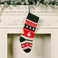 Fair Isle knitted Christmas stocking with snowman pattern hanging on a white fireplace - Snow Socks 2