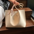 Large beige tote bag in lychee leather texture with a pink plaid scarf on the handle - White