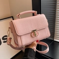 Elegant pink textured crossbody bag with gold T-lock and adjustable shoulder strap - Pink