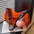 Bright orange saddle bag with black logo strap and pink plush peach pendant - With Charm / Orange