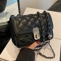 Quilted black leather crossbody bag with silver chain strap and metallic twist lock - Black