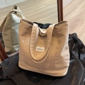 Beige high-capacity canvas tote bag with shoulder straps and white logo label - Khaki