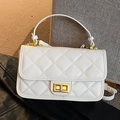 White quilted crossbody bag with golden twist lock and elegant top handle strap - White