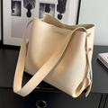 Minimalist cream beige leather bucket bag with wide shoulder strap in premium matte finish - Off White
