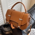 Brown leather crossbody bag with wide wavy strap and metallic silver buckle - Brown