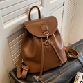 Brown leather backpack with matte finish featuring a drawstring closure and vintage gold hook - Brown