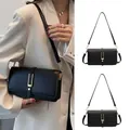 Classic black rectangular crossbody bag with elegant gold U-shaped metal buckle and strap - Black
