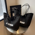 Minimalist black canvas tote bag featuring white JI CHUAN lettering and slim handles - Small / Black