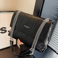 Black quilted chain shoulder bag with glossy texture and silver strap detail - Black