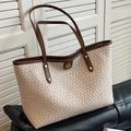 Beige woven tote bag with brown leather handles and a round gold logo plaque - Off-white