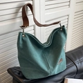 Dark green canvas bucket bag with brown leather straps and fashion label tag - Green