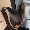 Dark grey canvas bucket bag with brown leather strap and stylish fashion label detail - Black