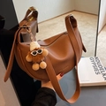 Brown lychee leather crescent saddle bag with a creative plush doll charm - With Charm / Brown