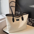 Chic cream and black oxford tote bag with minimalist logo on a stylish side table - Beige and Black