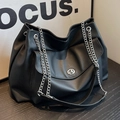 Large black faux leather tote bag with silver metal chain strap and turn-lock closure - Black