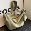 Olive green nylon hobo shoulder bag with crossbody strap and small round pouch charm - Green