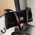 Classic black shoulder bag with gold hardware and stylish patchwork leather texture - Black