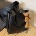 Black pebble leather bucket bag with fashion print and brown knit teddy bear charm - Black With Pendant