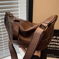 Dark brown leather crescent bag with wide jacquard strap and vintage bronze hardware - Brown