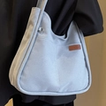 Bolso de hombro tipo cubo en lona azul claro con etiqueta de cuero y bolsillo frontal - Azul