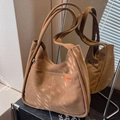 Large brown canvas tote bag with long double straps and premium texture on dark surface - Brown