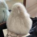 White faux fur crossbody bag with silver chain strap for a cozy winter style - White
