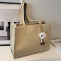 Large beige tote bag with natural leather texture and plush charm in a chic indoor setting - Off-white