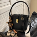 Black faux leather bucket bag with gold clasp and cute bunny charm on white book - Black with Pendant