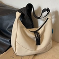Cream nylon crossbody dumpling bag with wide black strap and woven zipper details - Off White