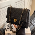 Classic black quilted leather crossbody bag featuring gold-tone ring clasp and chain strap - Black
