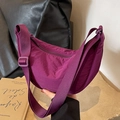 Magenta nylon crescent crossbody bag featuring an adjustable strap and smooth zipper - Purple