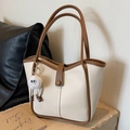 Chic beige leather tote bag with brown trim and cute plush monster charm accessory - Cream White with Pendant