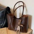 Brown vintage faux leather tote bag with a cute plush bunny charm for daily commuting - Brown