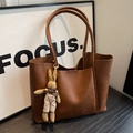 Brown faux leather tote bag with stylish pleated texture and cute rabbit charm pendant - Brown