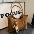 Brown vintage faux leather tote bag with a cute knitted bunny charm pendant - Tan