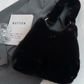 Chic black fuzzy faux fur handbag with elegant gold metal ring handles for winter - Black