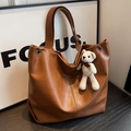 Brown faux leather tote bag with silver eyelets and a small knit bear charm - Brown (With Pendant)