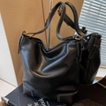 Classic black leather tote bag with white contrast stitching and gold hardware details - Black