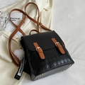 Quilted black and brown faux leather backpack with gold buckle and fuzzy pom-pom charm - Small Black