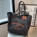 Dunkelgraue Canvas-Einkaufstasche mit orangefarbenem Aufdruck und Vintage-Schultergurt - Dunkelbraun
