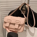 Pink lychee textured leather crossbody bag with flap and dual decorative buckles - Pink