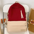Mochila de gran capacidad para estudiantes en diseño bicolor rojo y beige sobre una silla - Rojo