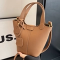 Brown lychee leather bucket bag with top handle and smiling charm pendant - Brown