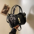 Black matte leather bucket bag with gold lock and houndstooth scarf handle detail - Black