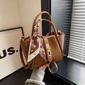 Brown matte leather bucket bag with top handle, decorative silk scarf and gold twist lock - Khaki