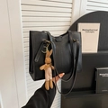 Classic black leather tote bag with a cute brown knitted rabbit charm and gold hardware - Black With Rabbit Pendant